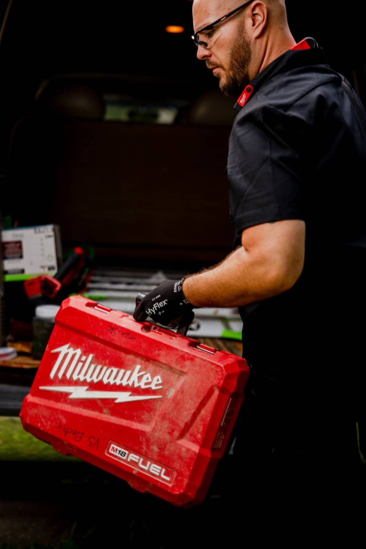 tom carrying milwaukee tools